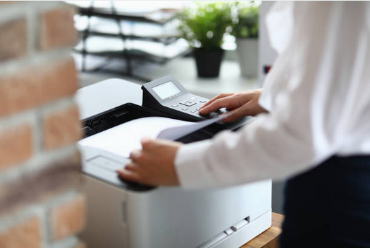 Man using a secure fax machine to send sensitive documents